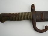 a close up of a knife on a white surface