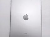 an apple ipad sitting on top of a table next to a white wall
