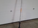 an image of a lawn mower in front of a garage door
