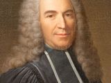 portrait of a man in a black robe with a white collar and a black tie