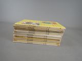 several children ' s books stacked on top of each other on a table