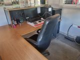 a desk with a chair and a computer on it