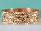 a close up of a gold ring on a white surface