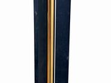 a tall black and gold vase on a white background
