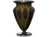 a glass vase that is sitting on a stand