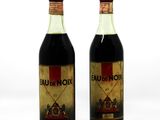 two bottles of wine sitting next to each other on a white surface