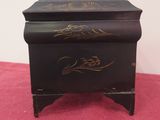 a small black box with gold writing on it
