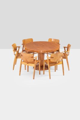 an image of a round dining table with six chairs around it