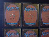 four decks of magic the gathering cards on a table