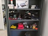 a black bookcase with many items on top of it