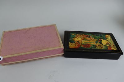 a small box with a painting on it next to a smaller box with a painting on it