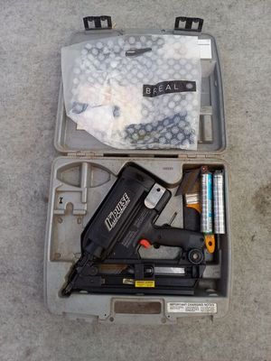 a box with a stapler, stapler, stapler, and other items in it