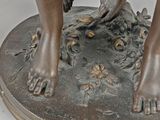 a bronze statue of a boy with a bird on his arm