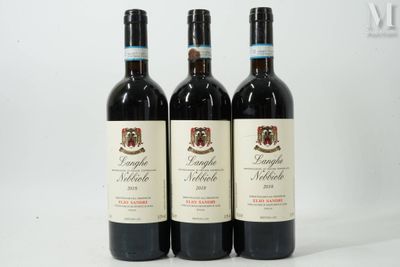 three bottles of red wine sitting on top of a white table