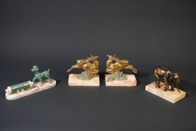 three bronze figurines of horses and a man on a horse drawn carriage
