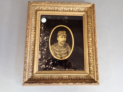 an old picture of a man in a gold frame on a wall