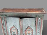a wooden cabinet with a door open and a clock on it