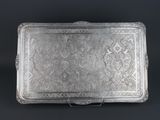 a silver tray with a floral design on it