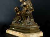 bronze statue of a woman and a child with a bird on her head