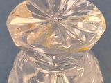 a clear glass jar with a flower inside of it