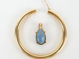 an image of a gold hoop with a blue stone in it