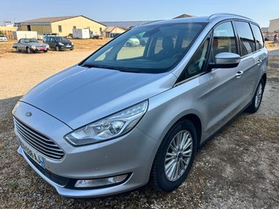 a silver ford grand tourer parked in a parking lot