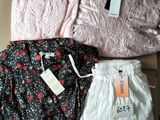 three pairs of women ' s shorts and a shirt in a box
