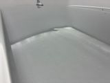 a white bathtub with a shower head and a shower curtain
