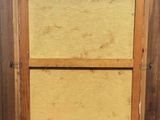 an old picture of a wooden frame with a window in it