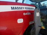 a large red tractor parked in a parking lot