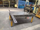 an image of a metal table in a warehouse with lots of shelves