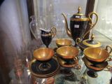 a glass table with a lot of gold and black items on it