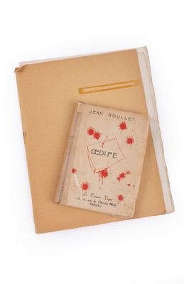 a book with a red heart on it sitting on a piece of paper