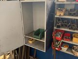 a metal cabinet in the middle of a room filled with assorted items