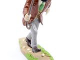 a figurine of a man with a sword and a backpack