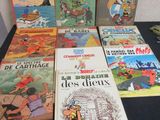 several children ' s books are lined up on a table in front of a wall