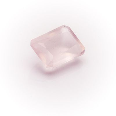 a pink quartz stone on a white background