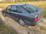 a car that is parked on the side of a dirt road