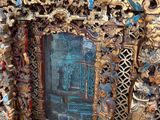 a picture of an ornate wooden frame with a blue door