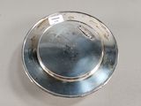 a silver plate on a table with a tag on it