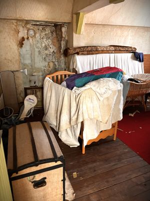 an image of a messy room with a bed and suitcases