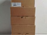 four cardboard boxes stacked on top of each other on a white surface