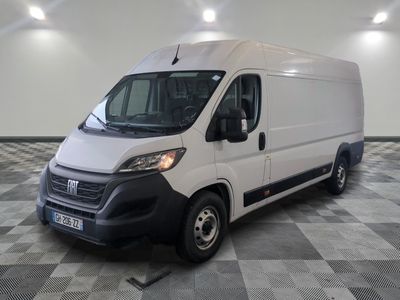 the white van is parked in a large room with checkered floor