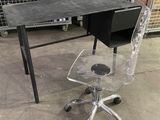 a desk with a chair and a computer on it in a warehouse