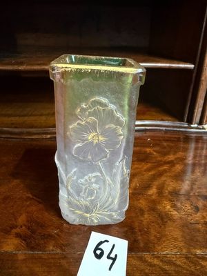 a glass vase on a table with a number on it
