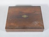 an old wooden box with a gold decoration on the lid