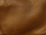 brown leather fabric with a small hole in the middle of it
