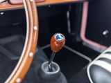 the steering wheel of an old car with a wooden stick in it