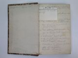 an old book with a piece of paper on top of it