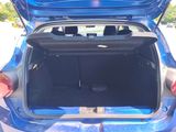 the back of a blue car with its trunk open showing the trunk space